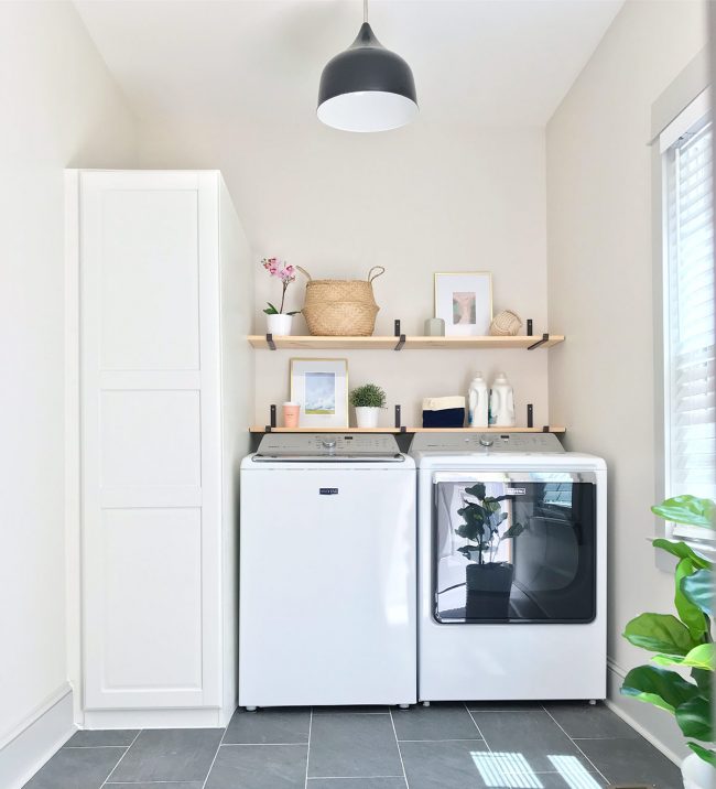 laundry room with top loading washer and ikea storage cabinet with floating shelves