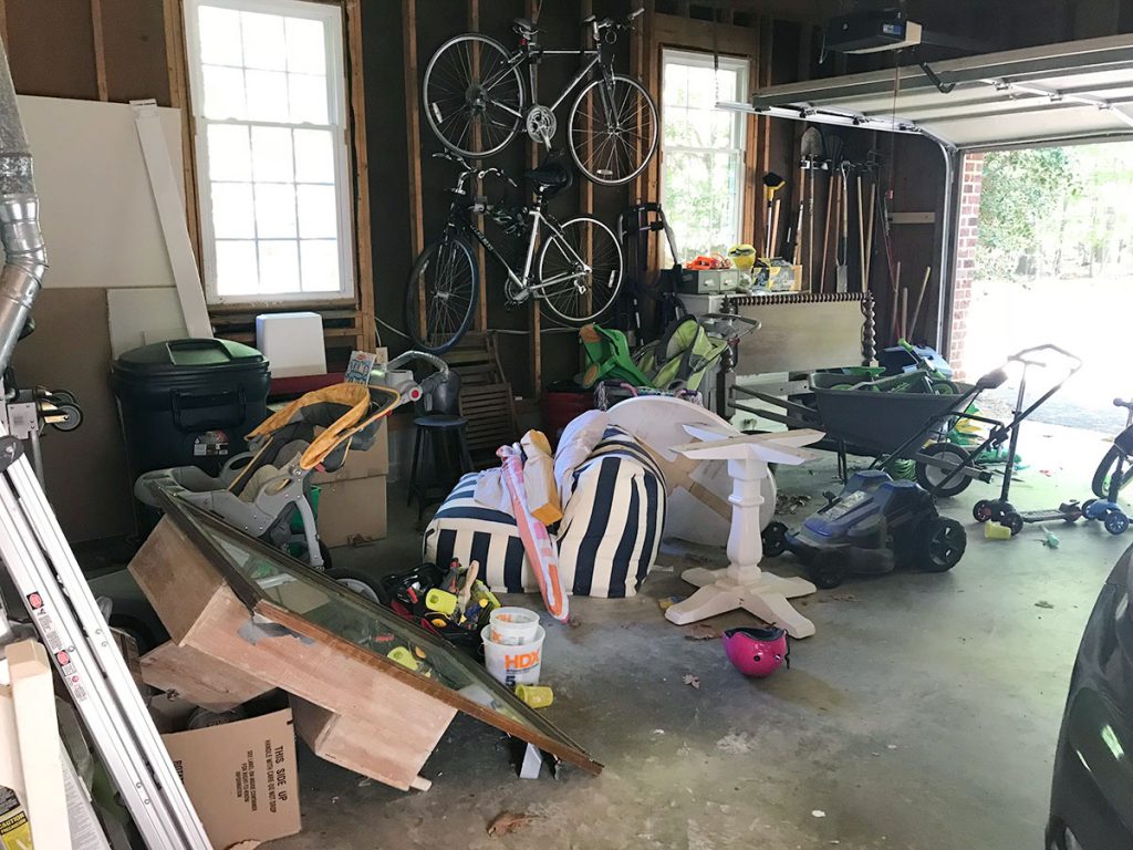 Messy garage with bikes and spare furniture