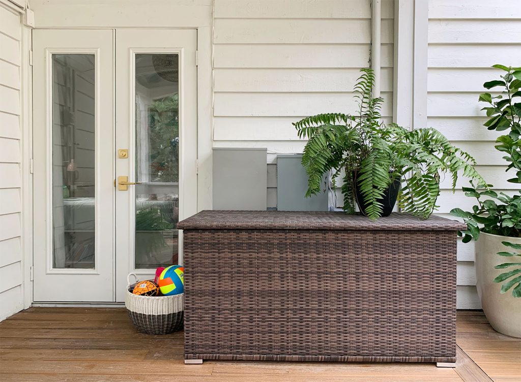 Large Woven Storage Bin On Porch With Fern On Top