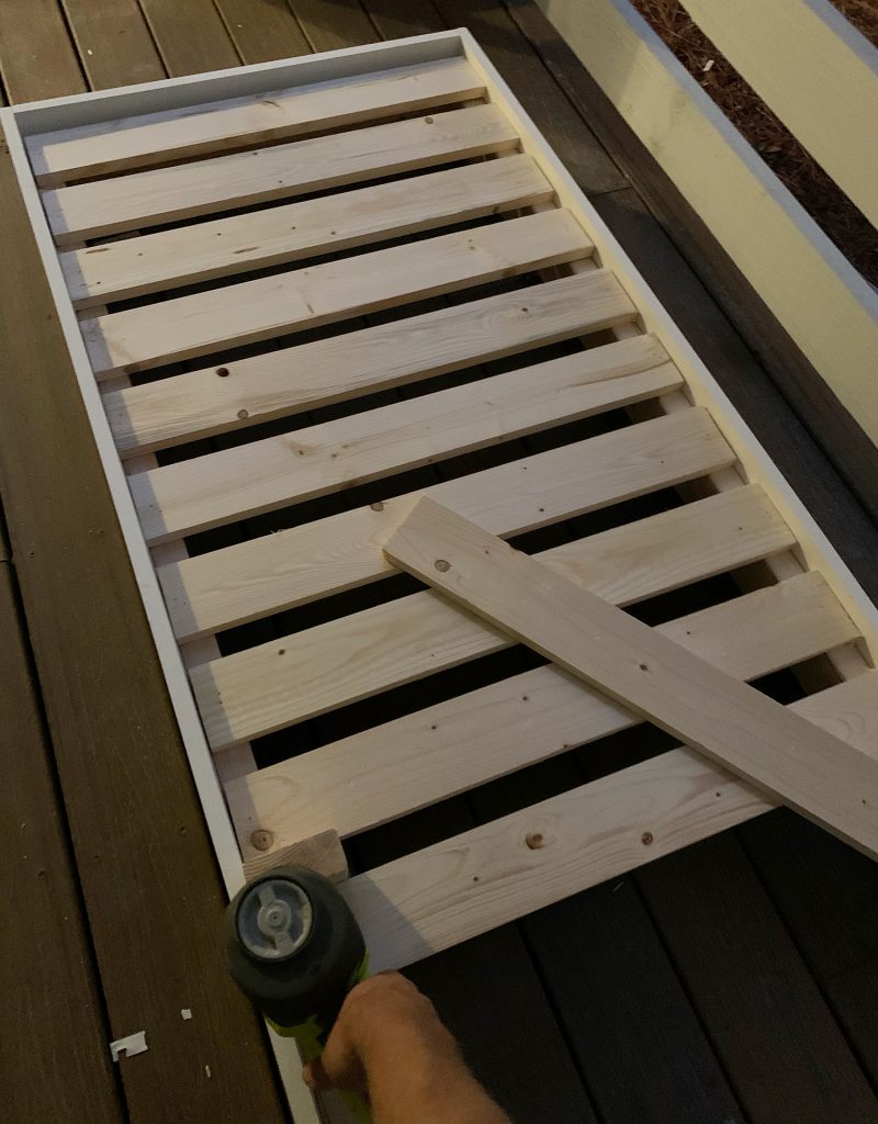 Nailing 1x4 slat across top of platform frame