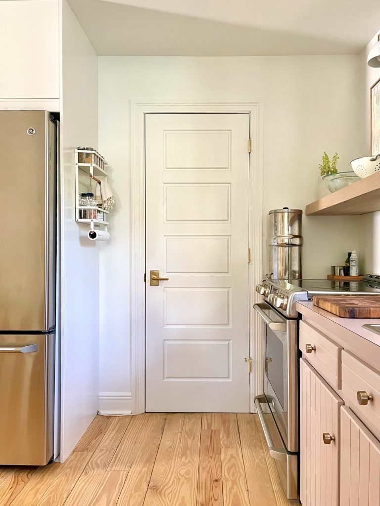 White Door To Kitchen Utility Closet With Spice Rack On Pantry Side