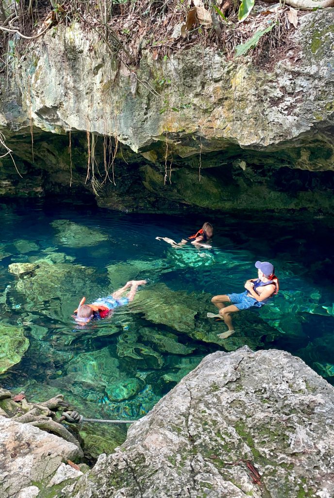 Kids Swimming in Cenote In Yucatan Mexico