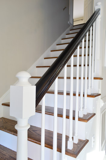stair railing makeover with white ballasts white pickets and dark railing