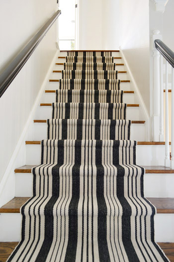 black and white stair runner installation after photo looking up the stairs